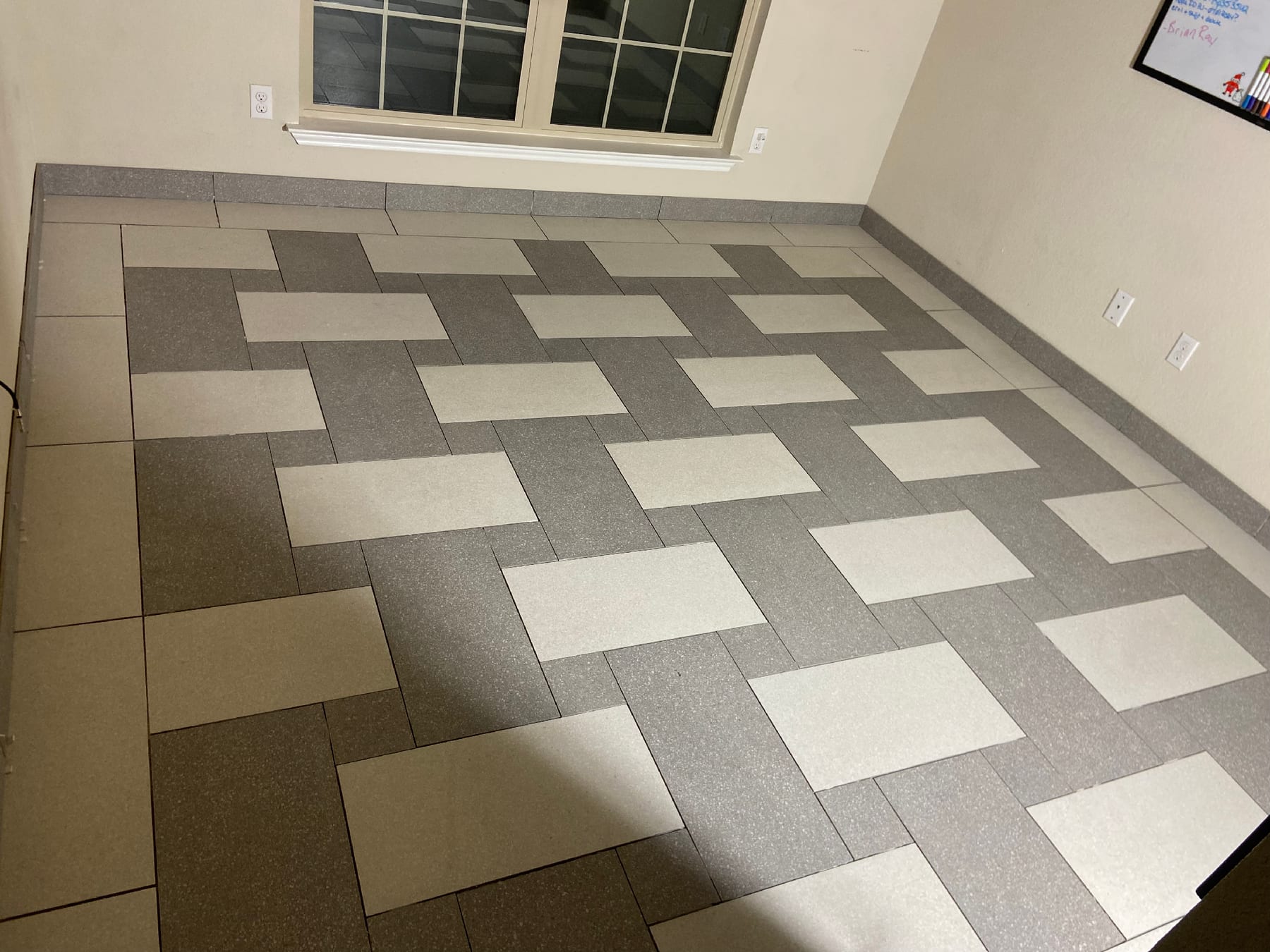 Two-tone basketweave porcelain tile floor in soft grays and cream, laid in a clean geometric pattern.